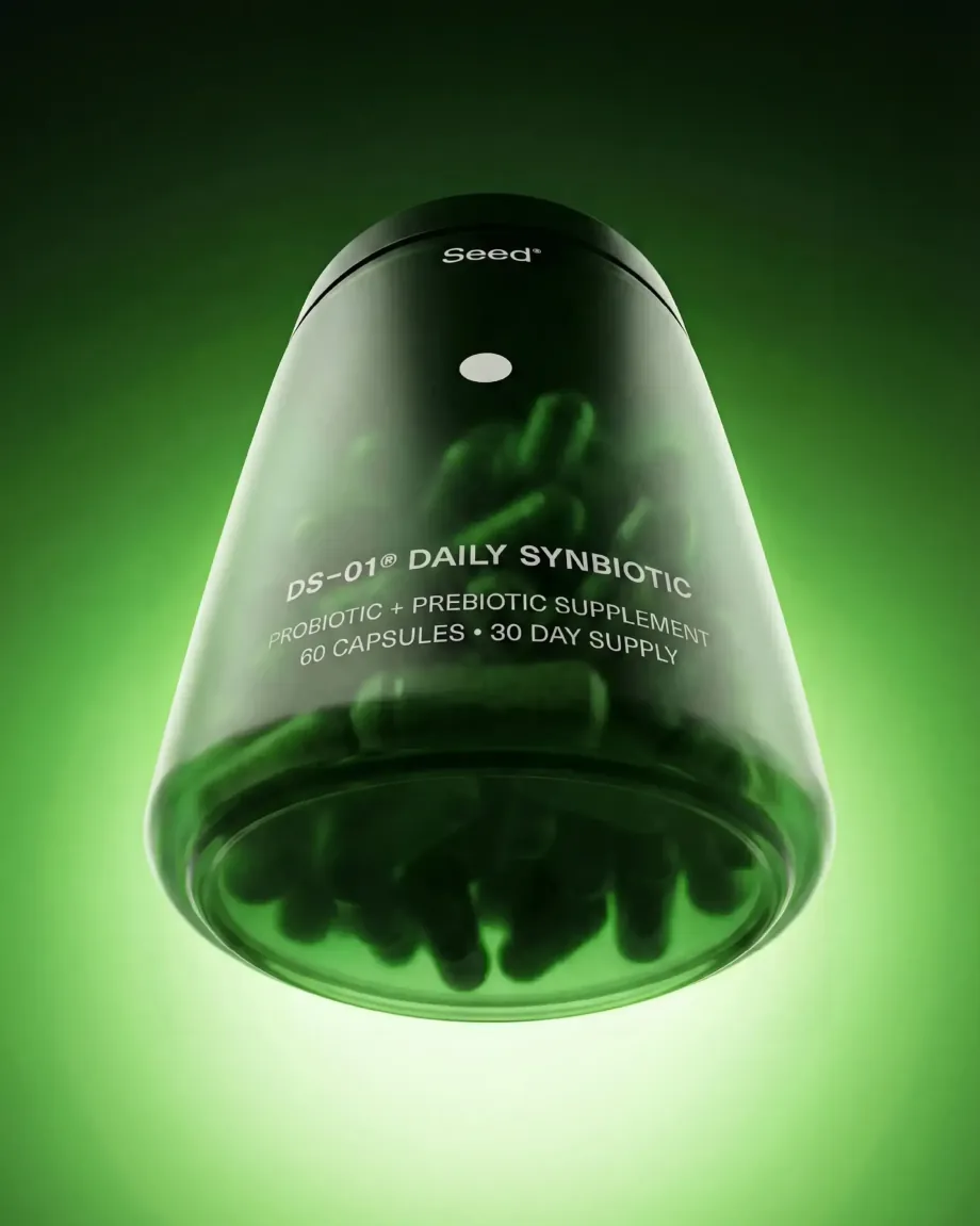 Seed DS-01 Daily Synbiotic jar tilted in green light